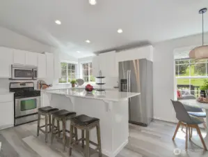 New quartz counters, flooring and stainless appliances in the kitchen.