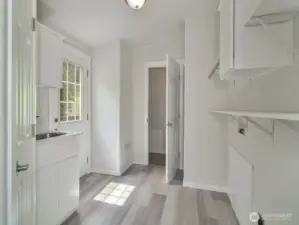 Large laundry and mud room with storage off the kitchen.