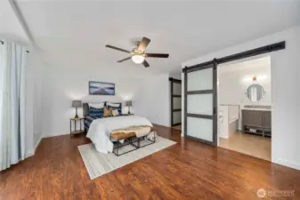 Barn doors lead to primary bath