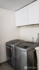 Utility room with cabinets and utility sink