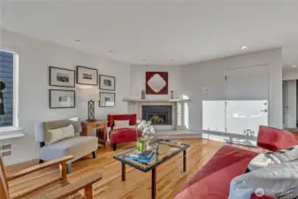 The front door of the home is shown on the right and a peek at the hallway to the bedrooms and backyard access.