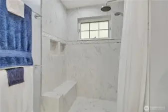 Large, remodeled bathroom with seating area and niches.  Nearly level entry with just a small curb.