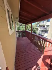 Upstairs covered deck/walkway. Nice little greenbelt in back