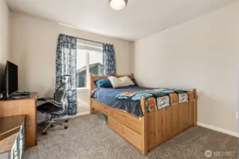 Still spacious but the smaller of the secondary bedrooms upstairs.