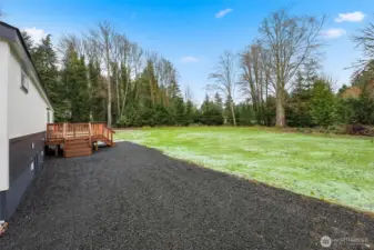 Back of home looking over your large lot (nearly 1 acre). Large deck provides ample space to enjoy this area in warmer months.