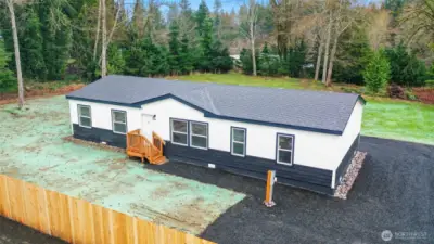 Aerial view showcasing privacy fence and lot.