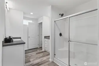 Primary bath with dual vanities and walk in shower with bench. Images shown are of a model home and are provided for reference only. Actual home may vary. For illustrative purposes only.