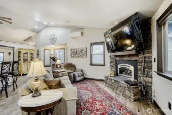 This cozy living room is open to the kitchen and overlooks the backyard and deck. Gas fireplace, vaulted ceiling, light and bright! New flooring througout this gorgeous home.