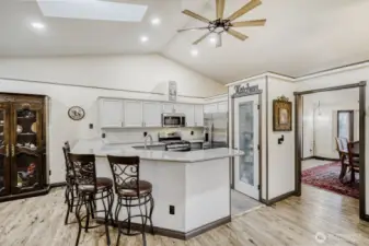 Bar seating at the kitchen counter. Opens to dining room and livng room.