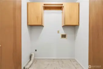 Laundry area with cabinets