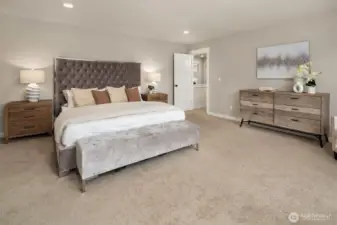 Spacious primary bedroom on second floor with ensuite bath and private balcony.