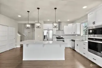 Uh, hello beautiful! Heart of the home right here with a chef's grand kitchen, massive island, flows together to the family room and table area