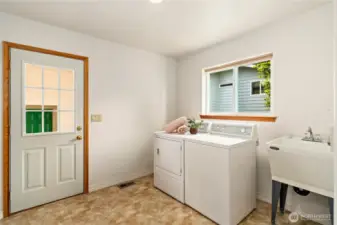 Enter the utility room under the breezeway off the garage. The utility room also offers tons of storage cabinets!
