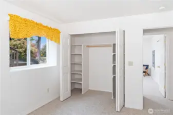 Bedroom #2 closet with built-in shelves.