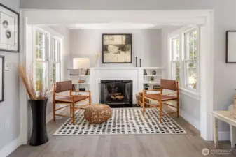 Sun-kissed study nook with cozy wood fireplace and built-in bookshelf, a perfect area for reading or unwinding.