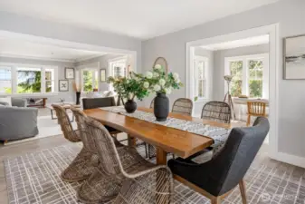 Easily accommodates a 10–12 person dining table, formal sitting area, and side buffets for entertaining at scale
