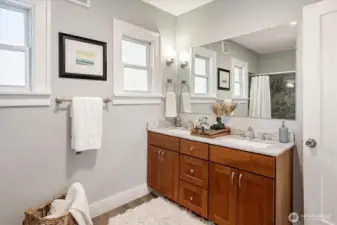 Fully renovated bathroom featuring ceramic tile, contemporary vanity with double sink, and quality faucets