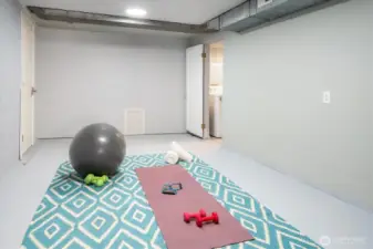 Spacious, finished, and heated rec room is ready for movie nights, workouts, creative project.