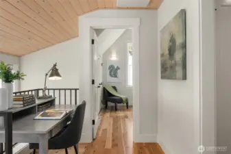 Upstairs two large bedrooms enjoy vaulted ceiling spaces enveloped with warm pine ceilings.