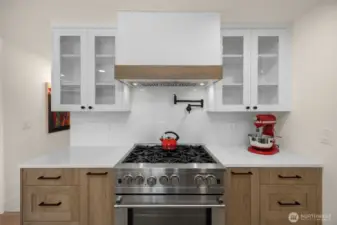 One of a kind range/hood design. Twotone cabinetry design is chic and blends perfectly.