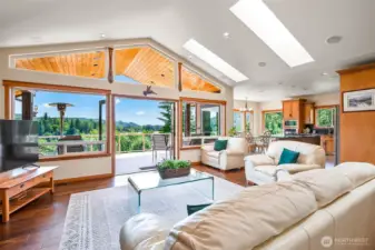 Living room with a tranquil lake view and vaulted ceilings