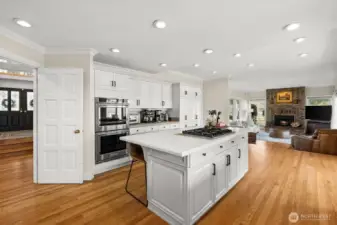 French doors can close off the kitchen from the front door entrance and primary suite which is to the left of this doorway.