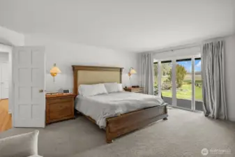 Main floor Primary Suite with double door entry as well as a slider to the deck, with hot tub (buyer to verify working condition).