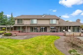 Expansive back deck with multiple slider access points and entertaining areas.