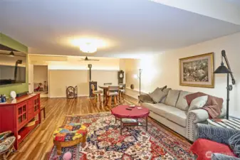 Generous family room featuring a cozy pellet stove and space for a game table.