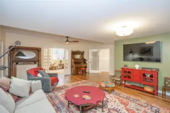 Another view of the family room looking into the extra finished room behind the glass pocket doors.