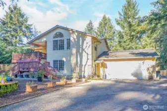 Close-up view of the home showing the lower-level entry to the left of the 34x24 garage.