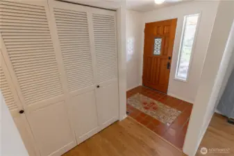Front entry with beautiful tilework and large coat closet