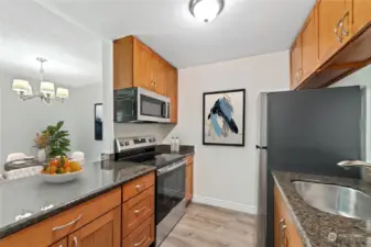 Beautiful cherry cabinets, new stainless appliances and slab granite countertops!  This photo has been virtually staged.