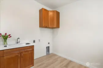 Utility room with sink and folding table off of mudroom.