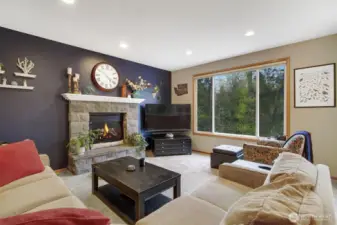Family room with gas fireplace, large picture windows.