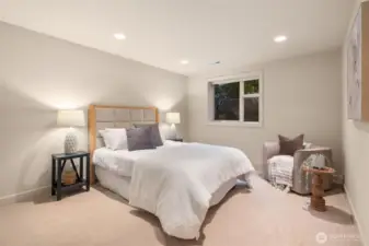 An expansive lower-level bedroom offers exceptional privacy, complete with a large closet and serene, tucked-away comfort.