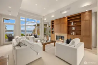 Custom cabinetry pairs seamlessly with a wall of expansive windows, creating a sophisticated and luxurious ambiance that elevates the entire space.