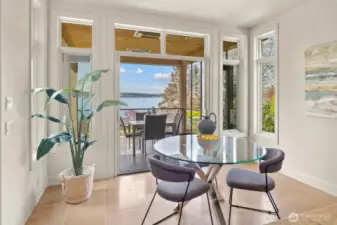 An inviting eat-in kitchen seamlessly flows into a generous patio, where the indoor dining experience effortlessly extends to the outdoors.