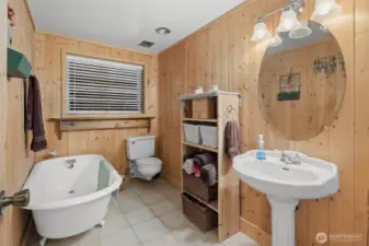 Powder room with claw foot soaking tub.