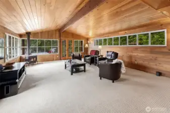 Large open family room off the kitchen with woodstove.