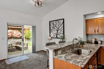 Sliders off dining area lead to incredible, fully-fenced backyard