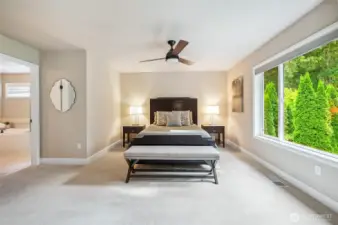 Tranquil primary suite with overhead fan.