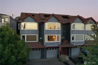 The evening light reflects off the large windows.