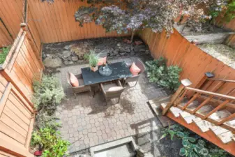 Private back patio with space for dining and container gardening.