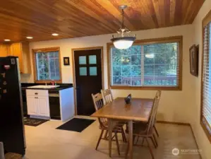 Dining area off kitchen that can easily be extended for entertaining. Expansive windows in dining and kitchen window invite the outside in.
