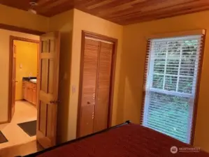 2nd bedroom has beadboard wood ceiling and closet with interior lighting, too.