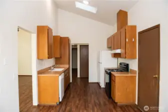 Vacant kitchen with professionally freshly varnished cabinets with ample storage and lots of potential.