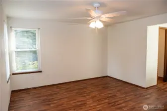 Vacant primary suite with new ceiling fan, walk-in closet and bath  to the right.