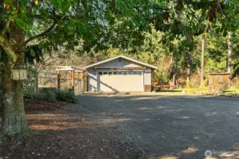 Double car detached garage with entry garden on left. Beautiful trees throughout this property.