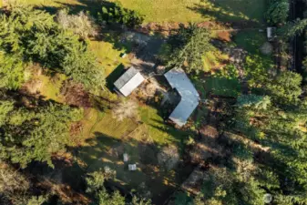 Aerial of home, garden and garage/studio. Property is five full acres. Two acres are deer-fenced for livestock or gardening. Pasture has two paddocks.